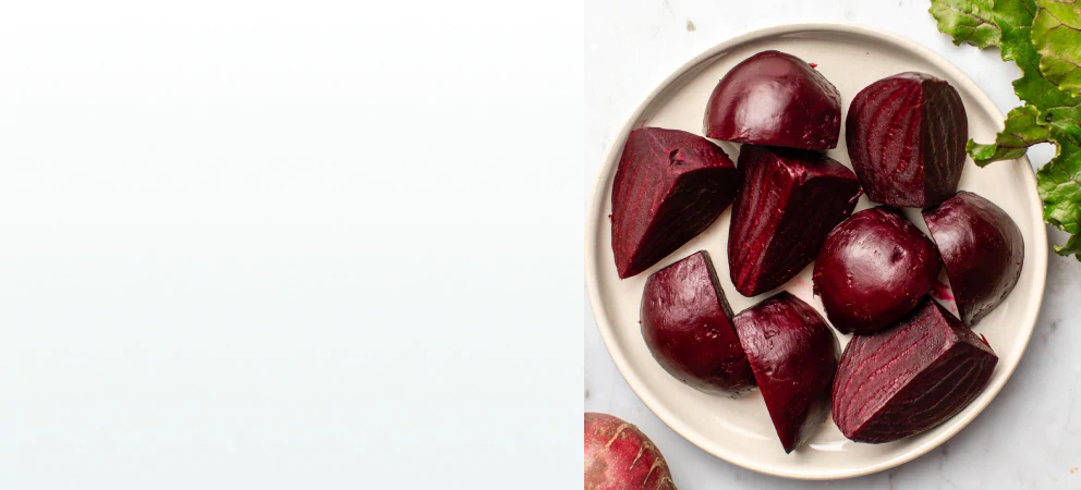 Freshly cooked and peeled beets cut into chunks on a plate, a natural ingredient found in supplements for liver health.
