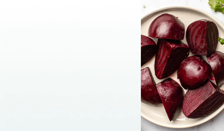 Freshly cooked and peeled beets cut into chunks on a plate, a natural ingredient found in supplements for liver health.
