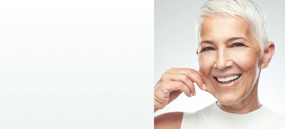 A radiant older woman with smooth skin smiling, symbolizing confidence and the benefits of supplements for skin and beauty.