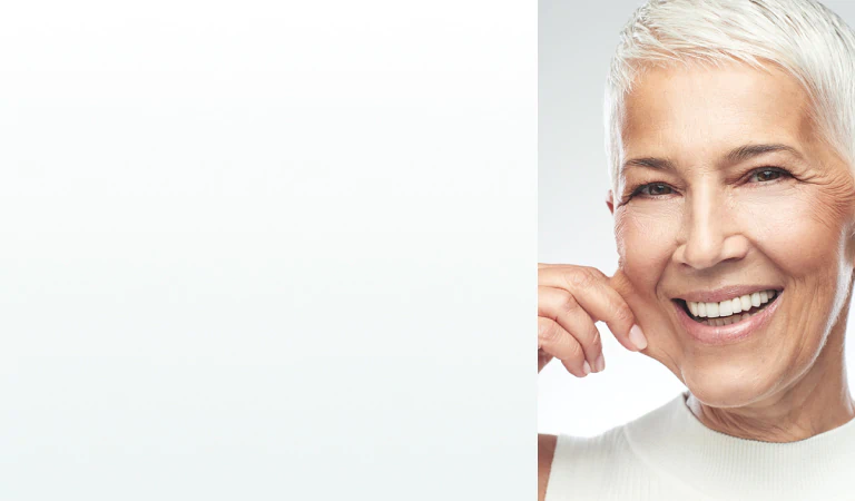 A radiant older woman with smooth skin smiling, symbolizing confidence and the benefits of supplements for skin and beauty.