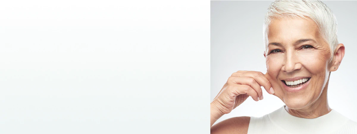 A radiant older woman with smooth skin smiling, symbolizing confidence and the benefits of supplements for skin and beauty.