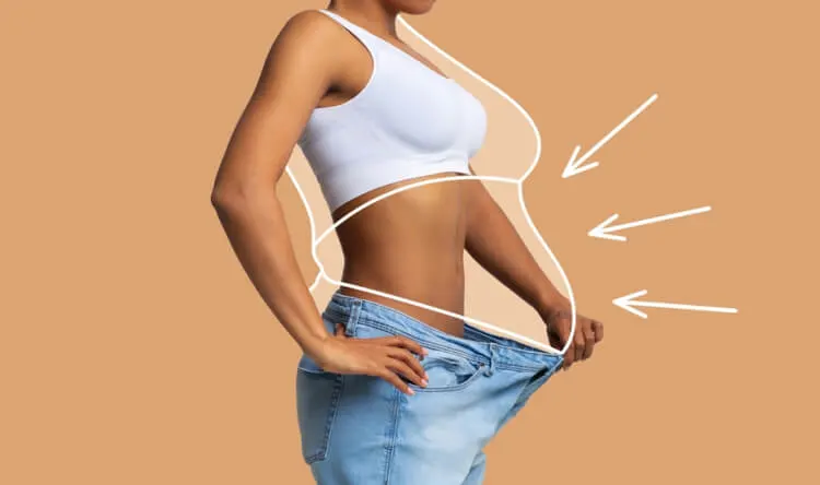 A fit woman wearing oversized jeans with drawn lines highlighting body changes, representing supplements for weight loss.